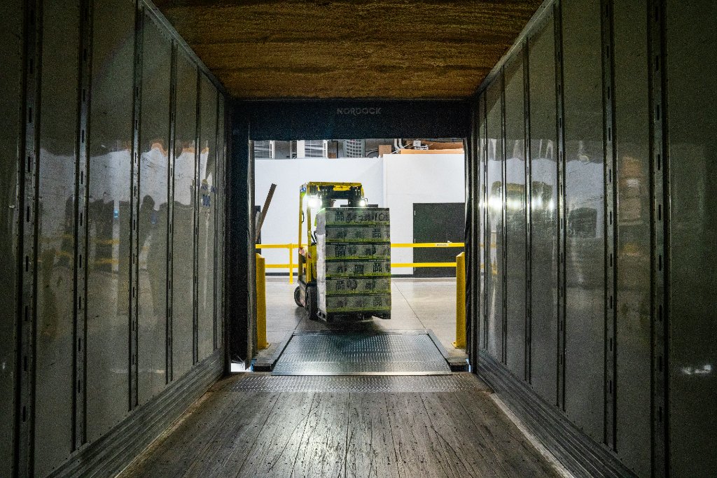 Pallet being loaded into a trailer at a warehouse dock